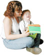 photograph of mother reading to young child