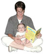 photograph of mother reading to baby